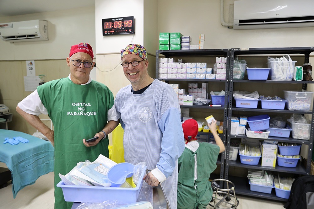 Two volunteer surgeons in the supply room before a day of operations